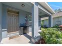 Cozy front porch featuring decorative accents, stylish furnishings, and lush landscaping, enhancing curb appeal at 219 Meghan Cir, Deland, FL 32724