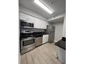 Bright kitchen featuring stainless steel appliances and stylish black countertops at 2207 Antigua Pl # 736, Kissimmee, FL 34741