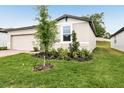 Well maintained front yard with green grass and various plants at 2310 White Tail St, Davenport, FL 33837