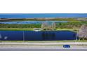 Scenic aerial view of the community pond, landscaping, and parking at 25 Lakeshore Blvd, St Cloud, FL 34769