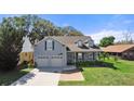 Charming two-story home with a manicured lawn, and a welcoming front porch at 25 Lakeshore Blvd, St Cloud, FL 34769