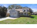 Charming two-story home with a manicured lawn, and a welcoming front porch at 25 Lakeshore Blvd, St Cloud, FL 34769