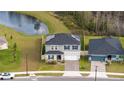 Charming two-story home next to a pond with solar panels and a brick paver driveway at 2984 Sanctuary Dr, Clermont, FL 34714