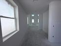 Unfinished hallway with bright natural light and several windows and light-colored walls at 30113 Misty Pines Rd, Mount Dora, FL 32757