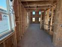 Interior view of a home under construction, showcasing exposed wooden framing and window placement at 30158 Rustic Mill St, Mount Dora, FL 32757