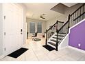 Bright entryway features tile flooring, staircase with black railings, and salon area at 3237 Palatka St, Orlando, FL 32824