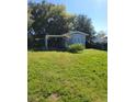 Spacious backyard featuring a covered area and lush green grass at 4202 Mizell St, Orlando, FL 32812