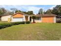Charming single-story home with a well-maintained lawn and landscaping at 453 Weathersfield Ave, Altamonte Springs, FL 32714