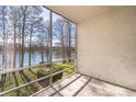 Relaxing screened balcony with serene lake views, offering a peaceful outdoor retreat at 4575 S Texas Ave # 205, Orlando, FL 32839