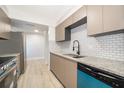 Modern kitchen features granite countertops, stainless steel appliances, and white subway tile backsplash at 4575 S Texas Ave # 205, Orlando, FL 32839