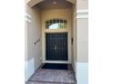 Welcoming entrance featuring double doors, an arched transom window, and brick-paved walkway at 4847 Lake Milly Dr, Orlando, FL 32839