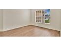 Serene bedroom with wood floors and a window that fills the room with natural light and brightens the space at 5071 Heatherstone Dr, Kissimmee, FL 34758
