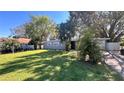 Lovely single-story home boasts a well-maintained lawn and mature landscaping, enhancing its welcoming curb appeal at 5200 Brosche Rd, Orlando, FL 32807