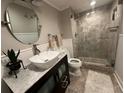 Charming bathroom with vessel sink, stylish vanity, and a frameless glass shower with elegant tile at 5337 Indian Creek Dr # C-4-1, Orlando, FL 32811