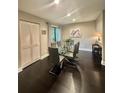 This elegant dining room has a glass table, sleek chairs, and a large window with natural light at 5337 Indian Creek Dr # C-4-1, Orlando, FL 32811