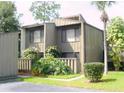 Inviting condo featuring a quaint landscape and a charming wood facade at 5337 Indian Creek Dr # C-4-1, Orlando, FL 32811