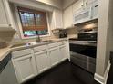 This cozy kitchen features white cabinets, modern appliances, and a window for natural light at 5337 Indian Creek Dr # C-4-1, Orlando, FL 32811