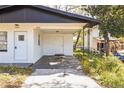 Close-up of white home carport, showing the entrance, and the architecture on a sunny day at 5604 7Th Se St, Lakeland, FL 33812