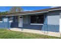 Exterior front view with blue brick facade and solar panels on the roof at 7813 Arabian Pl, Orlando, FL 32818