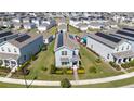 Aerial view of a neighborhood showcasing modern homes with solar panels at 9747 Petition Way, Orlando, FL 32832