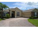 Beautiful home showcasing a brick paver driveway leading to an attached two-car garage at 4847 Lake Milly Dr, Orlando, FL 32839