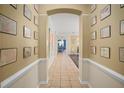 Bright hallway featuring tiled flooring and decor, leading to various areas of the house at 12824 Penshurst Ln, Windermere, FL 34786