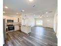 Bright, open kitchen featuring granite countertops and stainless steel appliances at 14 Locust Radial Way, Ocala, FL 34472