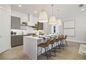 Stylish kitchen island with seating, pendant lighting, and modern cabinetry at 15567 Gentle Rain Dr # 194, Winter Garden, FL 34787