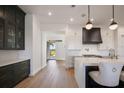 Bright, modern kitchen featuring a waterfall island, white cabinets, and stainless steel appliances at 15847 Vetta Dr, Bella Collina, FL 34756