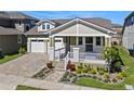 Charming home featuring a two-car garage and a beautifully landscaped front yard at 16144 Parkwyn St, Winter Garden, FL 34787