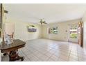 Spacious living room with tile flooring, ceiling fan, and a large window for natural light at 215 Forrest Dr, Sanford, FL 32773