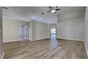 Spacious open floor plan with wood floors and archways leading to other rooms at 2156 Fish Eagle St, Clermont, FL 34714