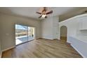 Bright living room with wood floors and sliding glass doors to a screened patio at 2156 Fish Eagle St, Clermont, FL 34714