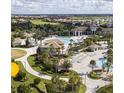 Aerial view showcases a luxurious community pool, clubhouse, and well-manicured green spaces at 218 Ocean Course Ave, Davenport, FL 33896