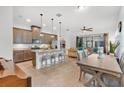 Open floor plan with kitchen island, wood cabinets, and stainless steel appliances at 2312 Datura Loop, St Cloud, FL 34772