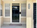 A close up of the front door with address number and window, shows curb appeal at 236 Eldorado Dr, Debary, FL 32713