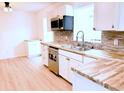 Beautiful kitchen with mosaic backsplash, wood counters, stainless steel appliances and a window at 236 Eldorado Dr, Debary, FL 32713