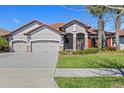 Lovely home boasting a terra cotta roof, a spacious driveway, and manicured landscaping at 2541 Shoal Bass Way, Kissimmee, FL 34746
