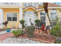 Charming front porch with seating, garden and elegant entryway on a well landscaped lot at 2747 Kissimmee Bay Cir, Kissimmee, FL 34744