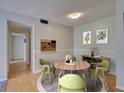 Inviting dining room with stylish decor, light wood floors, and a view to the kitchen at 3242 S Semoran Blvd # 21, Orlando, FL 32822