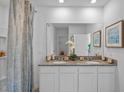 Bathroom featuring double sinks, granite countertops, and decorative elements at 3893 Diving Dove Ln, Bartow, FL 33830