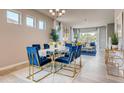 Bright dining area with modern chandelier, large windows, and open concept living space at 3971 Kennebunk Loop, Mount Dora, FL 32757