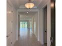 Bright entryway with neutral walls and tile flooring, leading to an open living space at 4203 Barbuda Ln, Kissimmee, FL 34758
