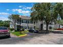 Exterior view of condo building with parking lot, sidewalks, and a blue car at 5144 City St # 238, Orlando, FL 32839