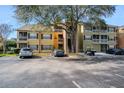 Exterior view of condo buildings showing parking and balconies, under a clear sky at 5144 City St # 238, Orlando, FL 32839