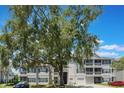 Exterior view of condos featuring garages, balconies, and stairs with landscaping in the front at 5144 City St # 238, Orlando, FL 32839