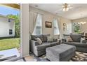 Comfortable living area featuring large windows and neutral decor at 612 Old Pine Ct, Sanford, FL 32773