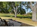 Enjoy the serene view from the backyard, overlooking lush greenery, mature trees, and a pond on the golf course at 6133 Seagull Ln, Lakeland, FL 33809