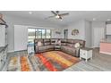 Open living room features stylish flooring, a large window with natural light, and a comfortable sectional sofa at 7699 Sw 74Th Loop, Ocala, FL 34481