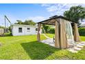 Backyard featuring a gazebo with privacy curtains, lush grass, landscaping, and the rear exterior of the home at 859 Neuse Ave, Orlando, FL 32804